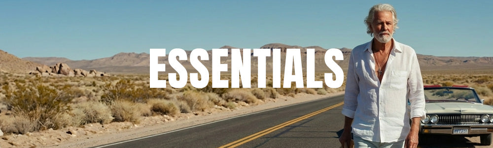 Man standing on a desert road with text 'ESSENTIALS' in the foreground